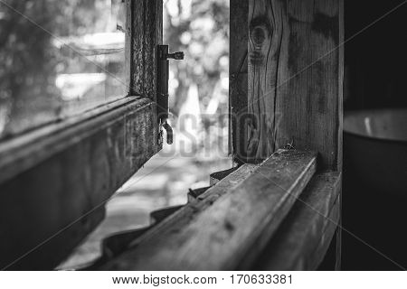 Looking through a rustic timber window black and white