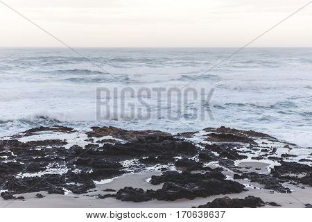 Waves crashing on the shore at sunset. Thor's Well Cape Perpetua Oregon USA.