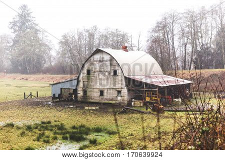 Old barn building in countryside landscape near the Oregon coast. Winter day setting.