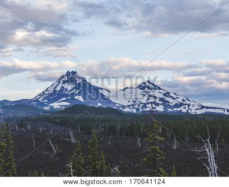 Beautiful mountain landscape view near Sisters Oregon USA. Blue sky with clouds above snowcapped mountains in western Oregon.