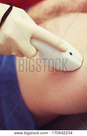 man receiving laser epilation at armpit on beauty center