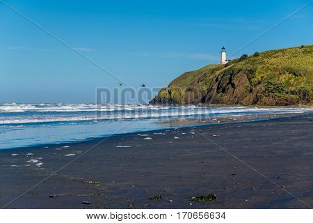North Head Lighthouse at Pacific coast, Cape Disappointment, built in 1898, WA, USA. Coast guard helicopters in the sky.