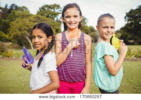 Kid posing at camera during a sunny day at park
