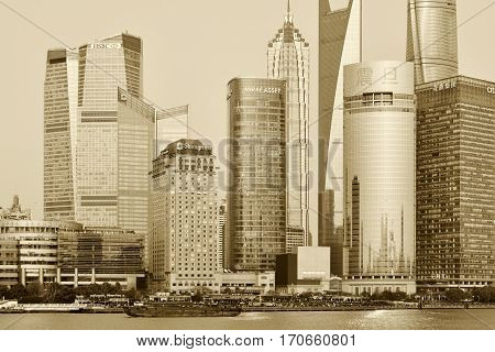 SHANGHAI CHINA - MARCH 25: Pudong district view from The Bund waterfront area on March 25 2016 in Shanghai China. Pudong is a district of Shanghai located east of the Huangpu River. Sepia toned photo