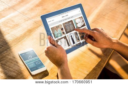 website frontpage against over shoulder view of casual man using tablet