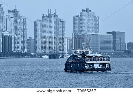 SHANGHAI CHINA - MARCH 25: Pudong district view from The Bund waterfront area on March 25 2016 in Shanghai China. Pudong is a district of Shanghai located east of the Huangpu River. Blue toned photo