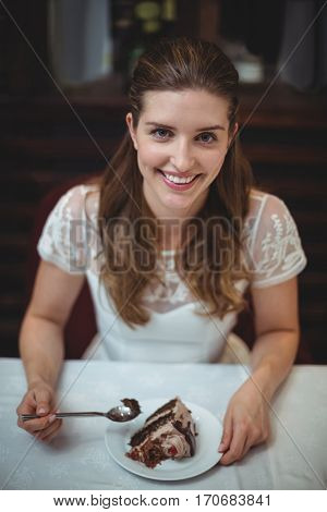 Portrait of happy woman with desert in restaurant