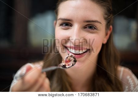 Portrait of smiling woman with desert in restaurant