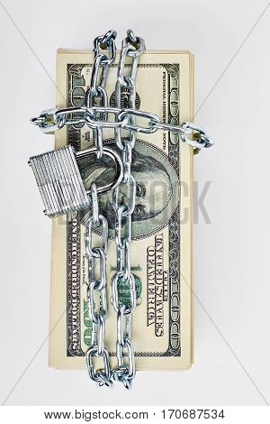 Locked stack of dollar bills. Safety and reliability.