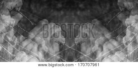 Lots of tortured hands grasping desperately barbed wire on black and white background