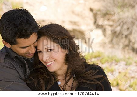 Portrait of a beautiful Hispanic couple laughing and smiling.