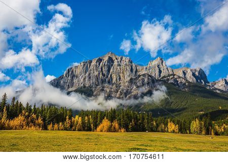 Auroral sunny day in Canmore. Concept of hiking. The famous Three Sisters mountains in the Canadian Rockies  of Canada