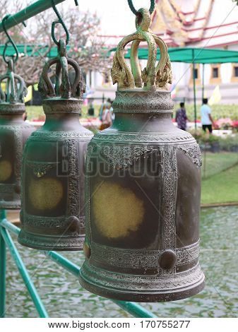 Big old bell hung beautifully arranged in a Buddhist temple.
