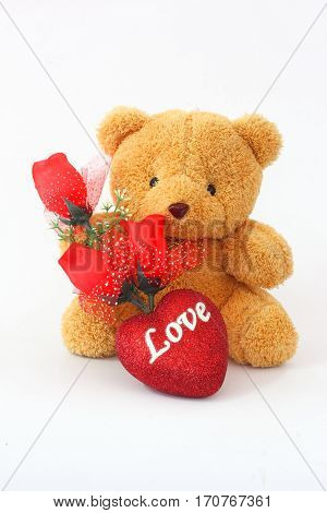 Brown teddy bears and red roses on a white background.