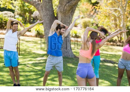 Group of friends exercising in park