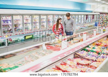 A concentrated couple in grocery store