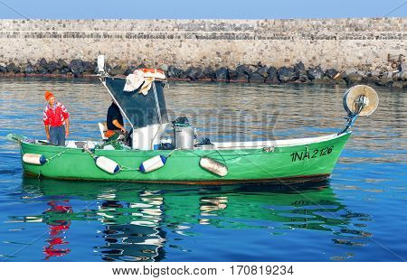 Ischia Italy - October 20 2008: A fishermen boat leavin the Ischia Porto harbor
