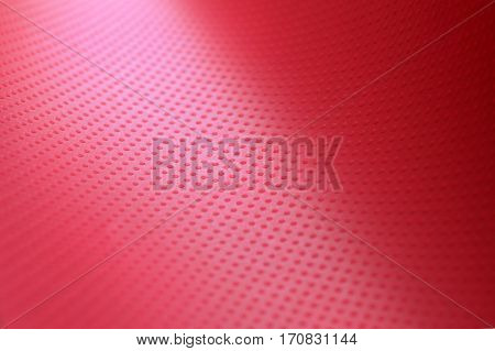 the texture of the paper sheet red-crimson color with volumetric texture points. Abstract soft focus. Background mode