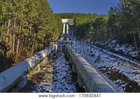 Water pipeline transporting water down to a valley accumulation station in wintertime, Pancharevo, Bulgaria