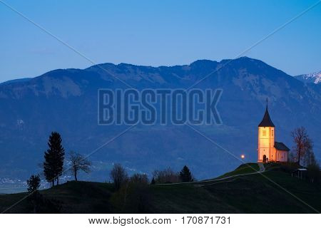 Lonely church on the hill at sunset at Jamnik Slovenia