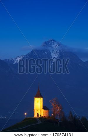 Lonely church on the hill at sunset at Jamnik Slovenia