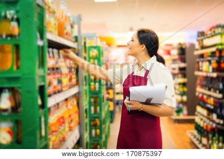 Female sales clerk working at the supermarket