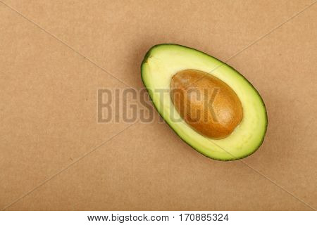Fresh Ripe Green Avocado On Brown Paper Parchment