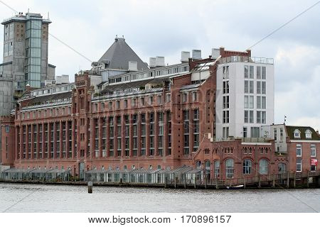 Netherlands Amsterdam june 2016: Old restored factory along river IJ