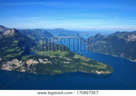 View from mount Fronalpstock. Lake Vierwaldstattersee in summer. Green meadows and mountains.