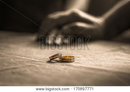 Love, Valentine`s Day And Wedding Concept. Two Wedding Rings With Man And Woman Hands Blurred In The