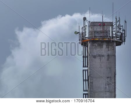 The large tall chimney that smokes heavily