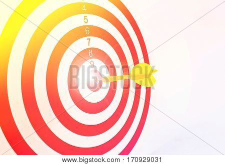 Colorful darts at a target. Red dart hit the aim.