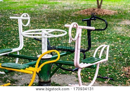 Old carousel for children 4 seats in the playground front focus blurred background