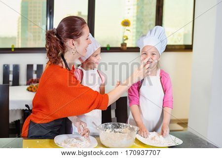 Lovely Children Together With Mother Preparing A Cake