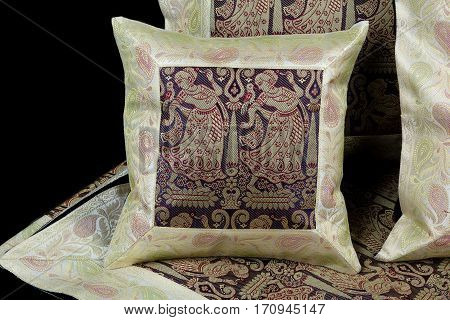 linens and pillows on a black background