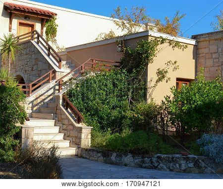 Stone stairs with railings and turns among the vegetation