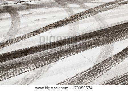 The Marks Of A Car Left On The Paved Road. The Photo Was Taken Close-up Small Depth Of Field. Winter