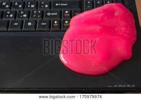 Keyboard Cleaning Gel Is Laying On The Keyboard. Notebook and Pink Gel.