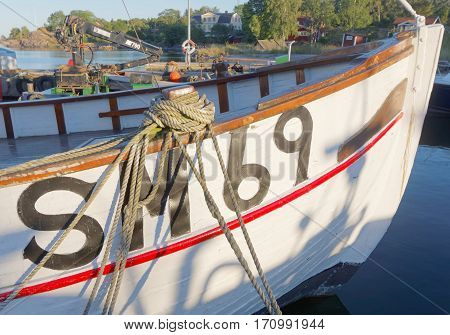 STOCKHOLM - JUL 31 2016: Closeup of fishing boat in the rural harbor at sunset. July 31 2016 in Grisslehamn Sweden