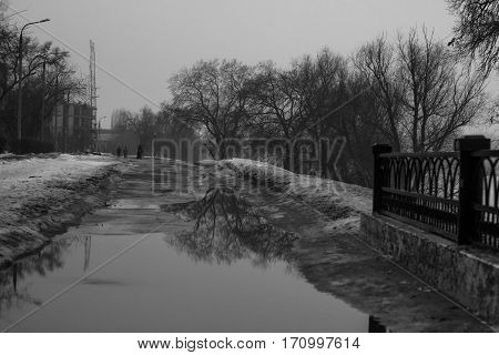 Winter city. Day. Pierce, the water in the river is frozen.