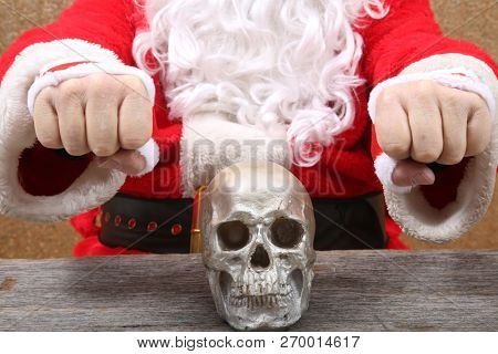 Santa Claus. Santa Claus holds a Human Skull. Santa finds an old Elf Skull. Old Man Winter is scared. Sold my soul to Santa. 
