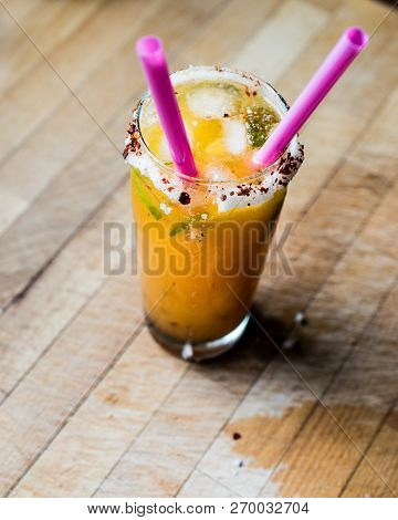 Mexican Michelada Cocktail With Beer, Lime, Ice And Spices..