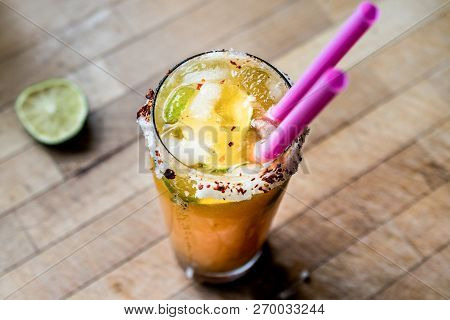 Mexican Michelada Cocktail With Beer, Lime, Ice And Spices..