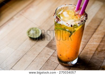 Mexican Michelada Cocktail With Beer, Lime, Ice And Spices..