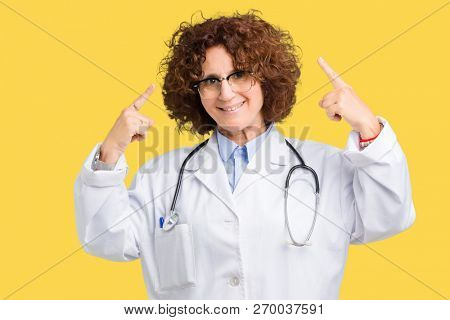 Middle ager senior doctor woman over isolated background Smiling pointing to head with both hands finger, great idea or thought, good memory