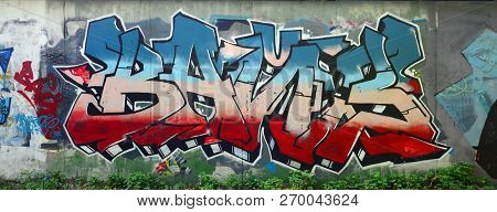 Full And Acomplished Graffiti Artwork. The Old Wall Decorated With Paint Stains In The Style Of Stre