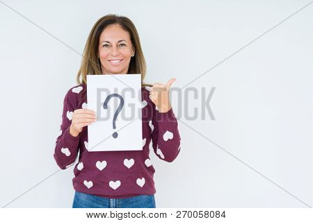 Middle age woman thinking and holding paper with question mark symbol over isolated background happy with big smile doing ok sign, thumb up with fingers, excellent sign