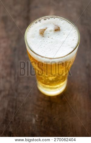 Glass Of Beer On Old Wooden Background