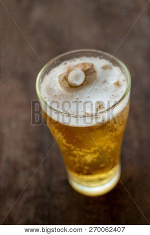 Glass Of Beer On Old Wooden Background