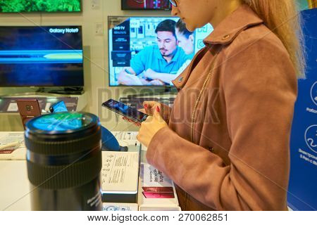 MOSCOS, RUSSIA - SEPTEMBER 20, 2018: woman hold smartphone at Samsung store in Moscow.
